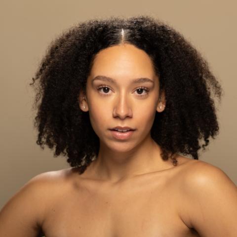 Lilly David headshot, posing in black bandeau