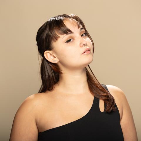 Morgan Thompson headshot: posing in a black off-the-shoulder tank top