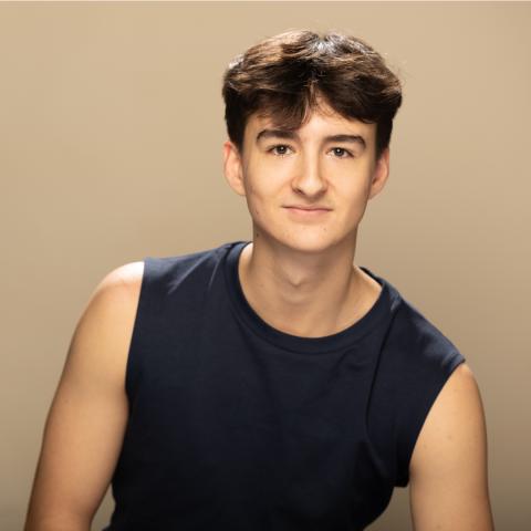 Nigel Clifford headshot, grinning in a black tank top