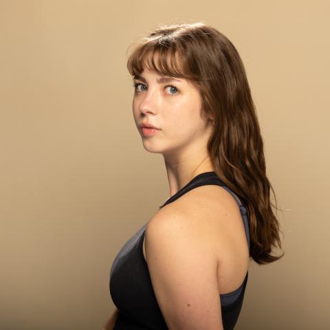 Nora Augustein headshot: posing in black shirt