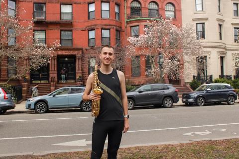 Xander Dawson with his saxophone on the Comm Ave Mall