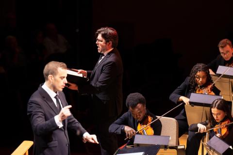 Michael Hanely (center), associate professor of voice, performs “Estuans interius” as conductor Stephen Spinelli (left) leads the Boston Conservatory Orchestra.
