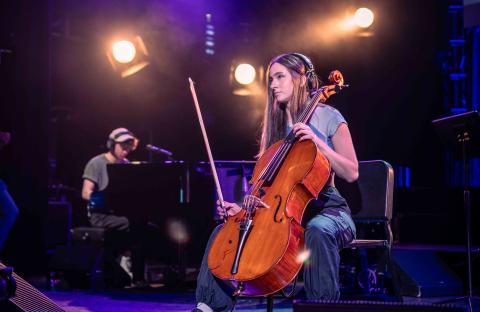 Elaina Spiro performing with her cello on stage