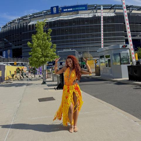Courtney Safford stands outside of FIFA world cup stadium. 